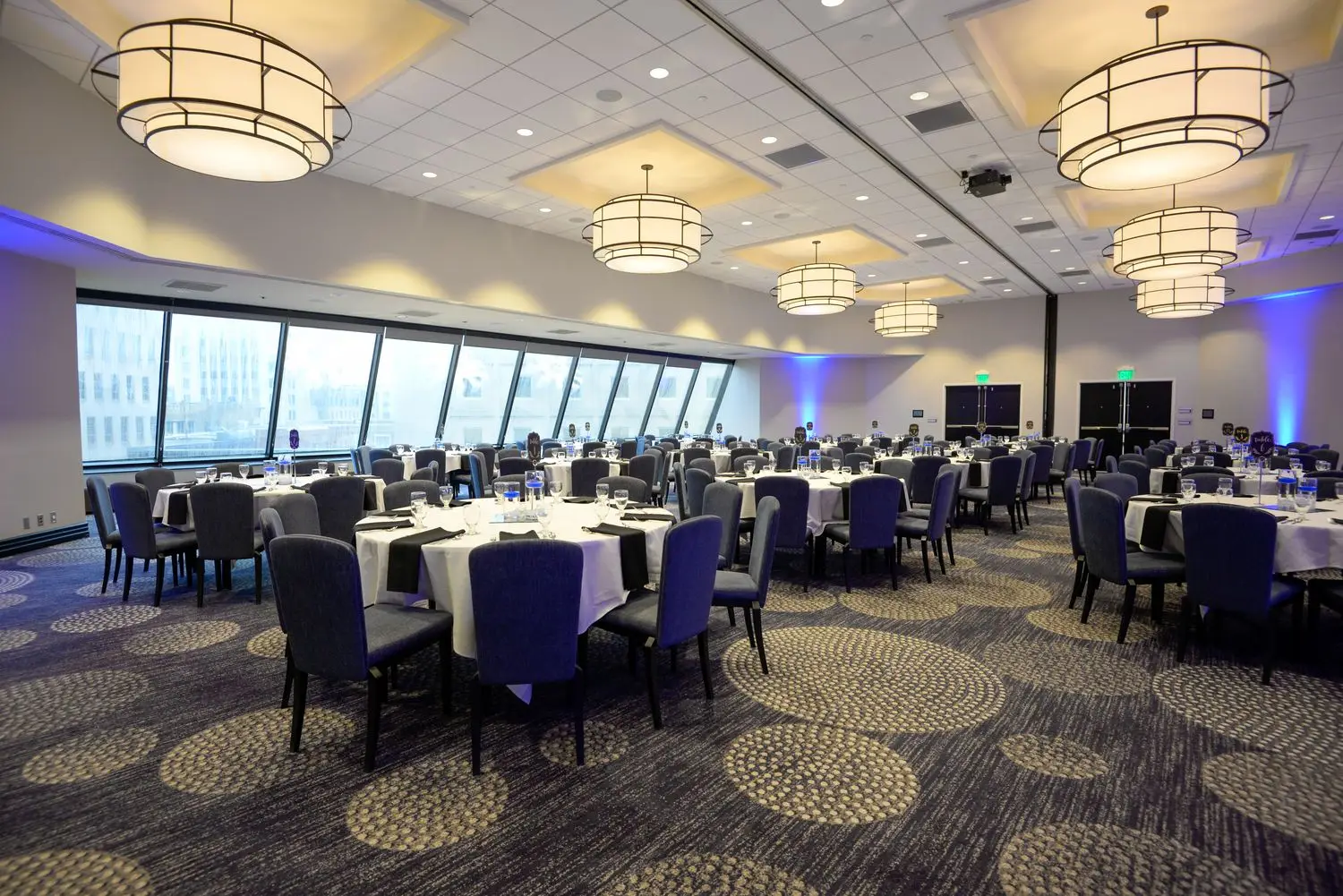 Corporate event room prepared with tables before guests arrive