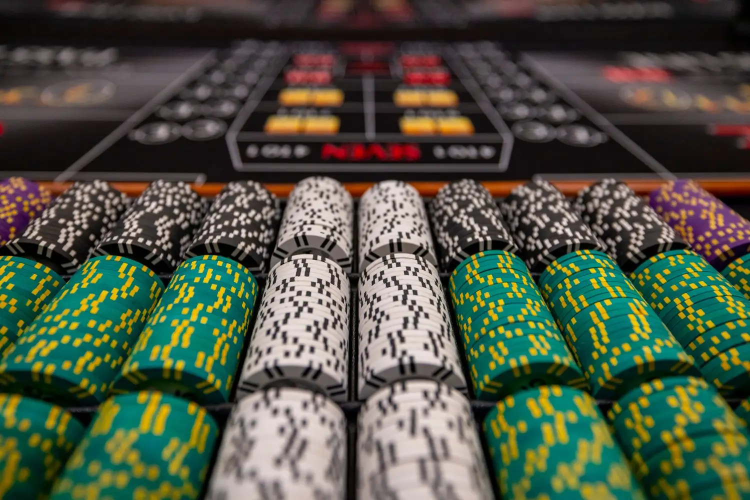 Organized poker chips prepared beside a table