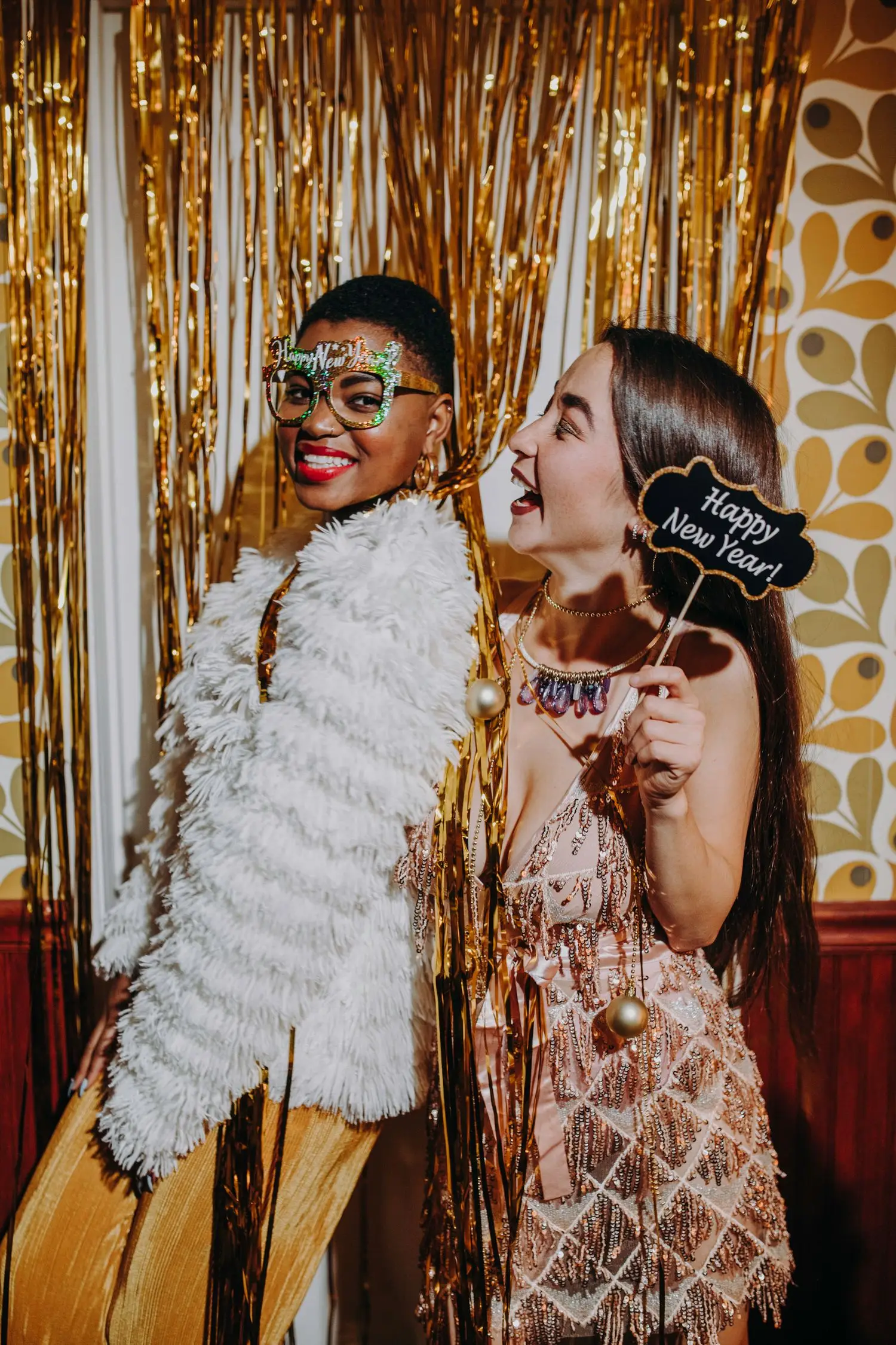 Guests using playful props in a decorated photo area