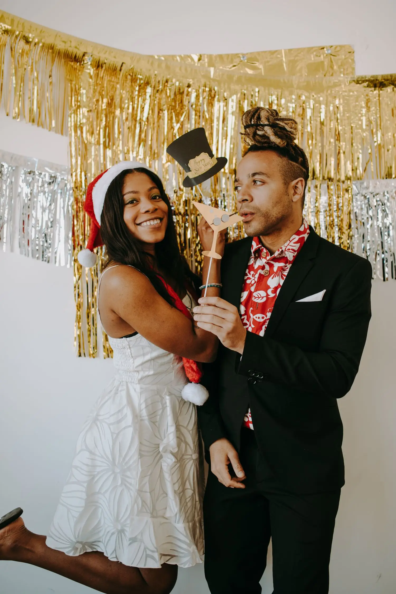 Two guests posing together at a styled photo zone